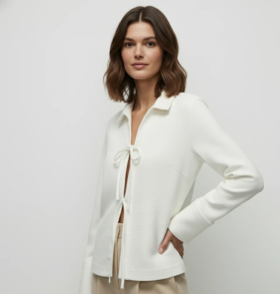 Sharon lightweight tie-front jacket in cotton-blend knit featuring a pointed collar, soft open front with fabric ties, flared sleeves and a clean, cropped silhouette. Minimal, refined layer to wear over tees, blouses or dresses for day-to-evening looks.