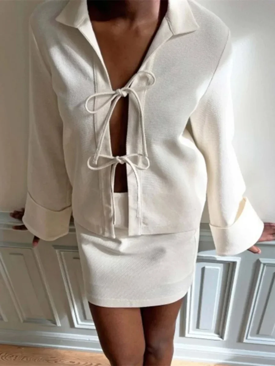 Sharon lightweight tie-front jacket in cotton-blend knit featuring a pointed collar, soft open front with fabric ties, flared sleeves and a clean, cropped silhouette. Minimal, refined layer to wear over tees, blouses or dresses for day-to-evening looks.