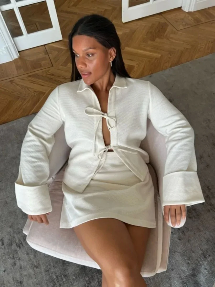 Sharon lightweight tie-front jacket in cotton-blend knit featuring a pointed collar, soft open front with fabric ties, flared sleeves and a clean, cropped silhouette. Minimal, refined layer to wear over tees, blouses or dresses for day-to-evening looks.