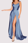 Long satin slit maxi dress featuring a soft cowl neckline, delicate tie straps and an open back. Body-skimming silhouette with light drape, gentle elastane stretch, full lining, hidden zipper and discreet side pockets—ideal for weddings and galas.