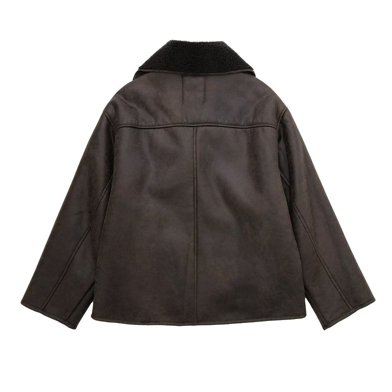 Women’s outerwear jacket in synthetic leather with plush shearling-effect lining, high stand collar and asymmetric button closure. Relaxed silhouette with lined hand pockets for cozy warmth and effortless layering from day to night.