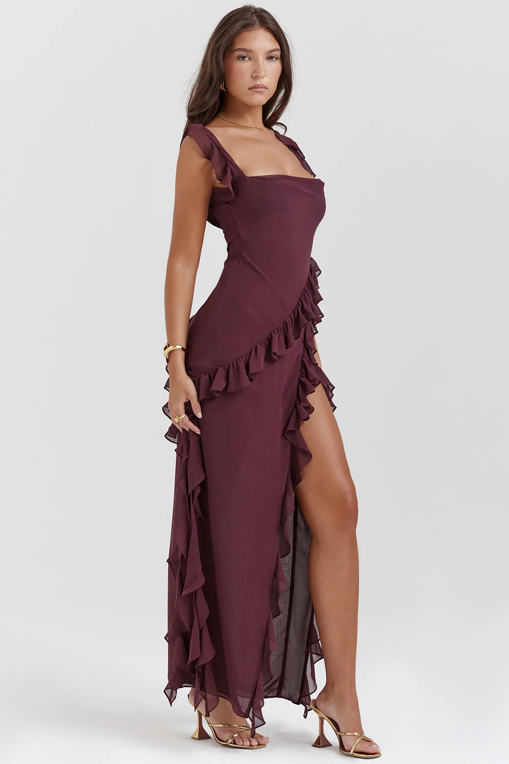 Tabitha Stylish Ruffle Dress in a maxi length featuring a square neckline, adjustable bow straps and a thigh-high side slit framed by cascading diagonal ruffles. Lightweight fabric skims the body, flattering the waist for chic day-to-night occasions.