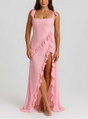 Tabitha Stylish Ruffle Dress in a maxi length featuring a square neckline, adjustable bow straps and a thigh-high side slit framed by cascading diagonal ruffles. Lightweight fabric skims the body, flattering the waist for chic day-to-night occasions.