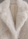 Women’s off-white faux-fur coat featuring a plush exterior, smooth lining and a clean, flattering silhouette. Lightweight yet warm, it layers effortlessly over dresses, knits or casual outfits—an elegant lined winter jacket for day or night.
