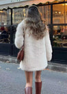 Women’s off-white faux-fur coat featuring a plush exterior, smooth lining and a clean, flattering silhouette. Lightweight yet warm, it layers effortlessly over dresses, knits or casual outfits—an elegant lined winter jacket for day or night.