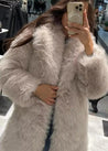 Women’s off-white faux-fur coat featuring a plush exterior, smooth lining and a clean, flattering silhouette. Lightweight yet warm, it layers effortlessly over dresses, knits or casual outfits—an elegant lined winter jacket for day or night.