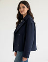 Maya wool-blend double-breasted cropped trench coat in a tailored silhouette with wide lapels and structured shoulders. Warm, durable and comfortable layer for autumn and winter, styled with denim, skirts or trousers.
